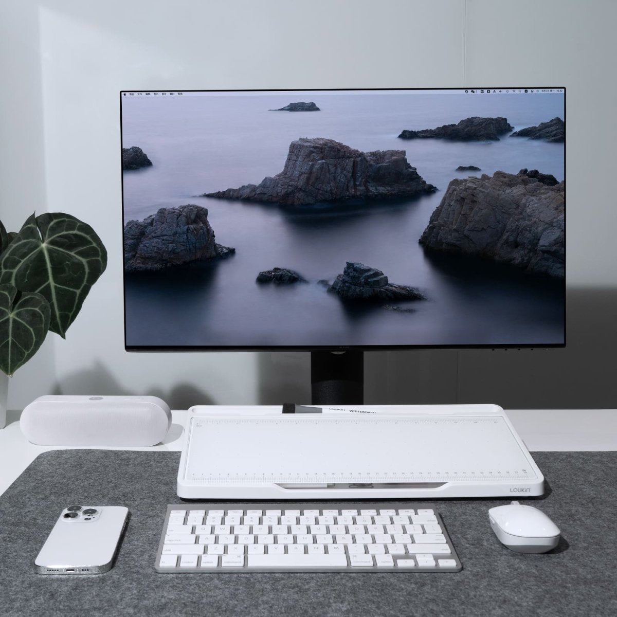 loukin W1701K GlassDesktopWhiteboard in white featured on a minimalist, organized desk setup. The tilted glass board is positioned beneath a computer monitor, with a keyboard, mouse, and smartphone neatly arranged in front of it, showcasing its use as an ergonomic monitor stand and modern writing surface for a clean workspace.