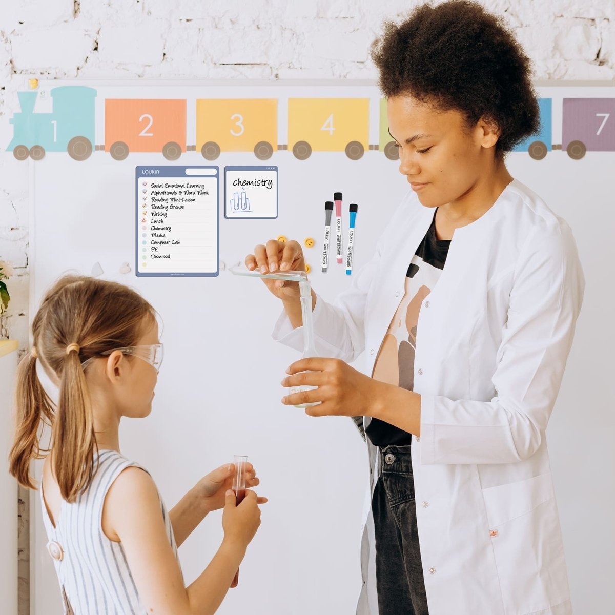 A lifestyle image showing a girl studying at a desk with the LOUKIN Monthly Plan and Checklist Dry Erase Calendar Set (model W1307K). The Checklist board is displayed upright next to a laptop, listing study and home tasks, emphasizing the use of the set for **student and family organization**.