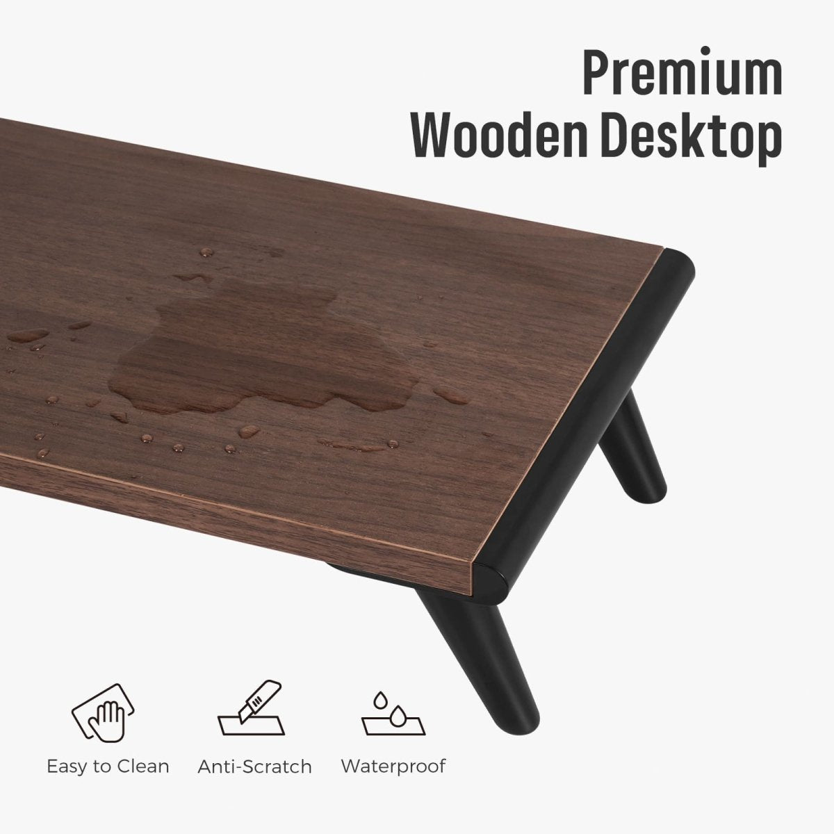 Close-up shot of the dark wood grain desktop surface of the Loukin Single Monitor Stand Riser (S4101), highlighting its Premium Wooden Desktop features. Water droplets are visible on the surface, emphasizing its Waterproof, Easy to Clean, and Anti-Scratch properties, with the stand legs in black.