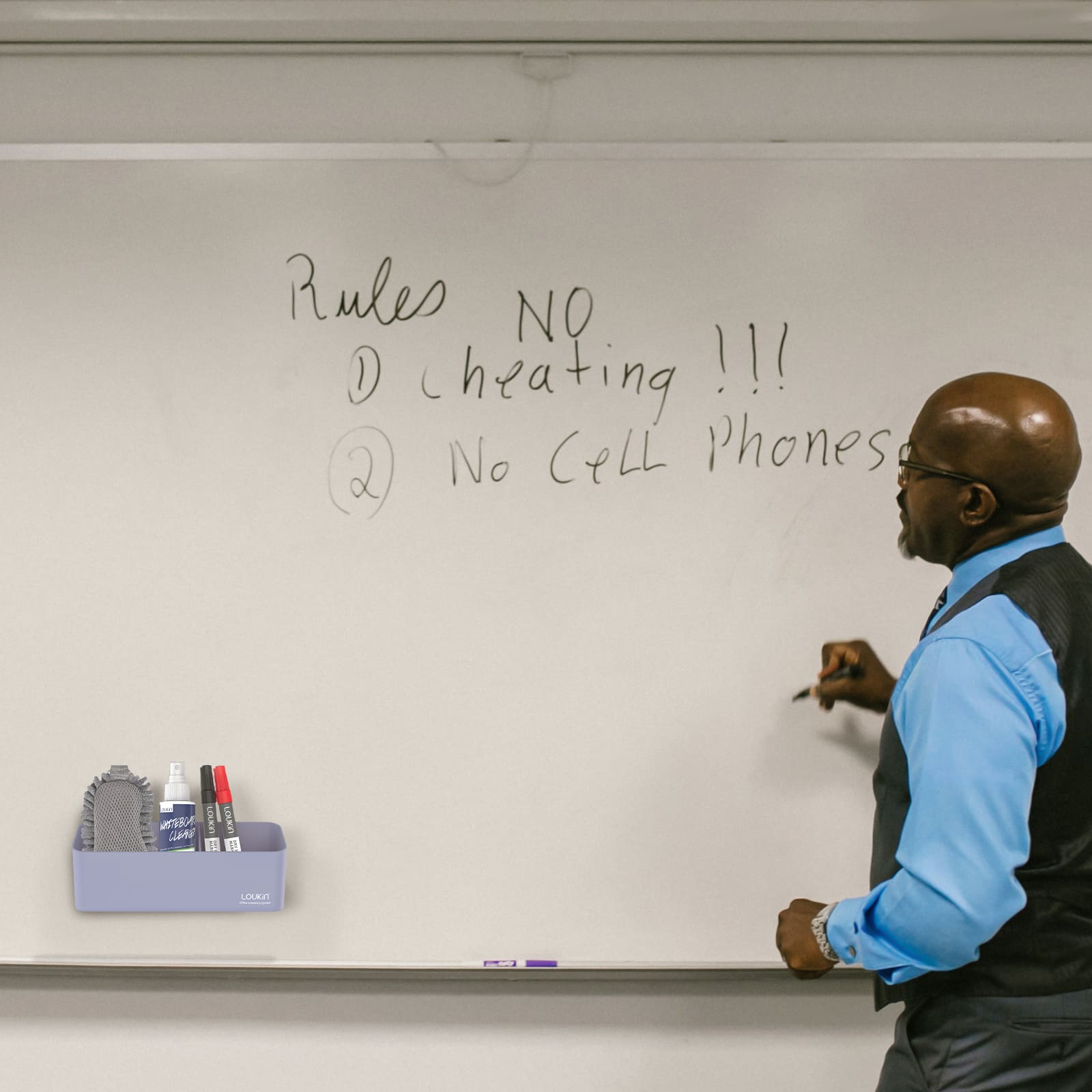 loukin W4102 MarkerHolderBig in light purple color, magnetically attached to a large whiteboard in a classroom. The large holder is shown storing whiteboard accessories (eraser glove, cleaner, markers) while a male teacher in a blue shirt writes class rules on the board, demonstrating its use for educational organization.