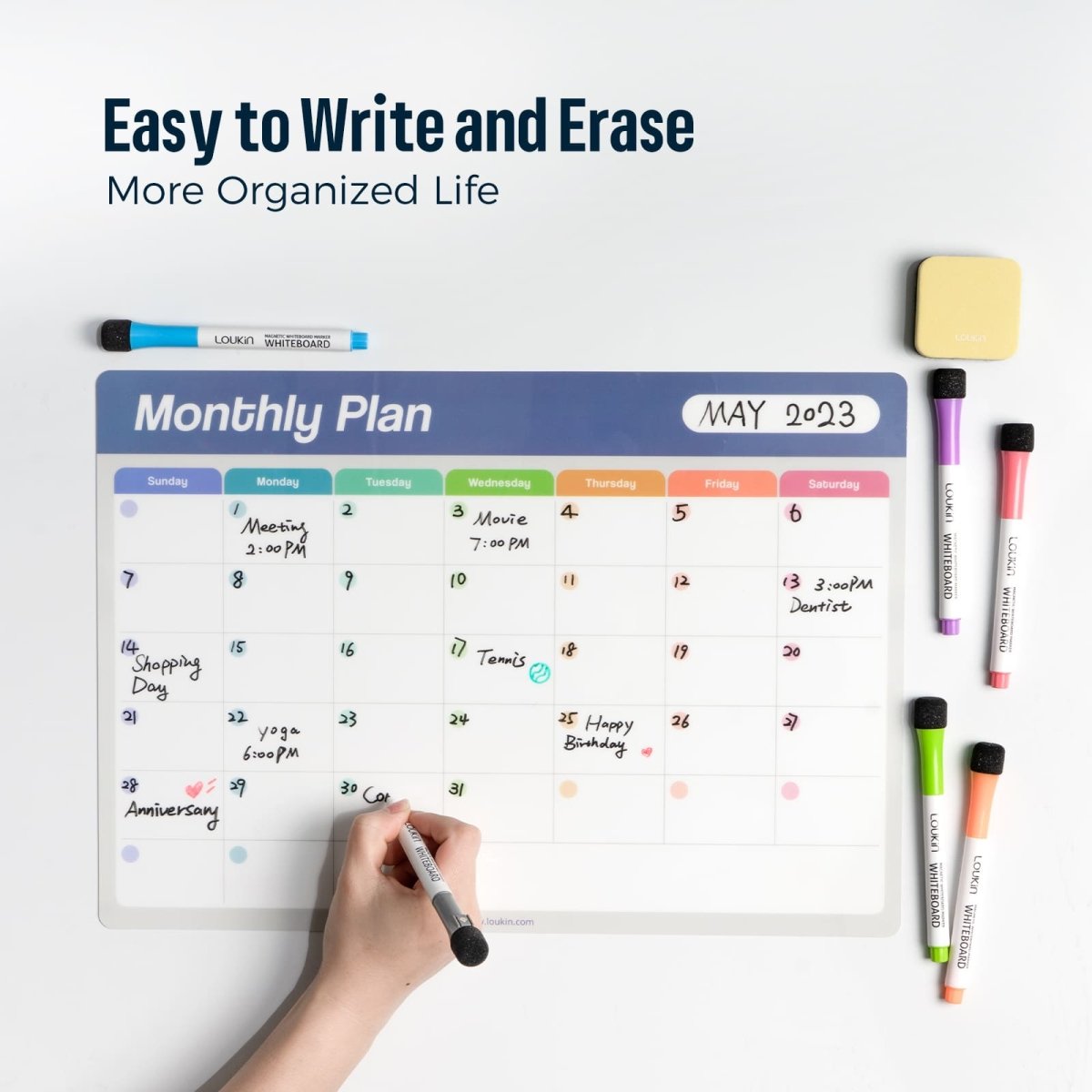 An in-use product image of the LOUKIN Static Cling Dry Erase Monthly Calendar (model W1303K) with a hand writing in the May 2023 dates and events. The image highlights the benefits: **"Easy to Write and Erase"** and living a **"More Organized Life"**.